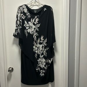 Black shift dress with silver flowers with attached cape.